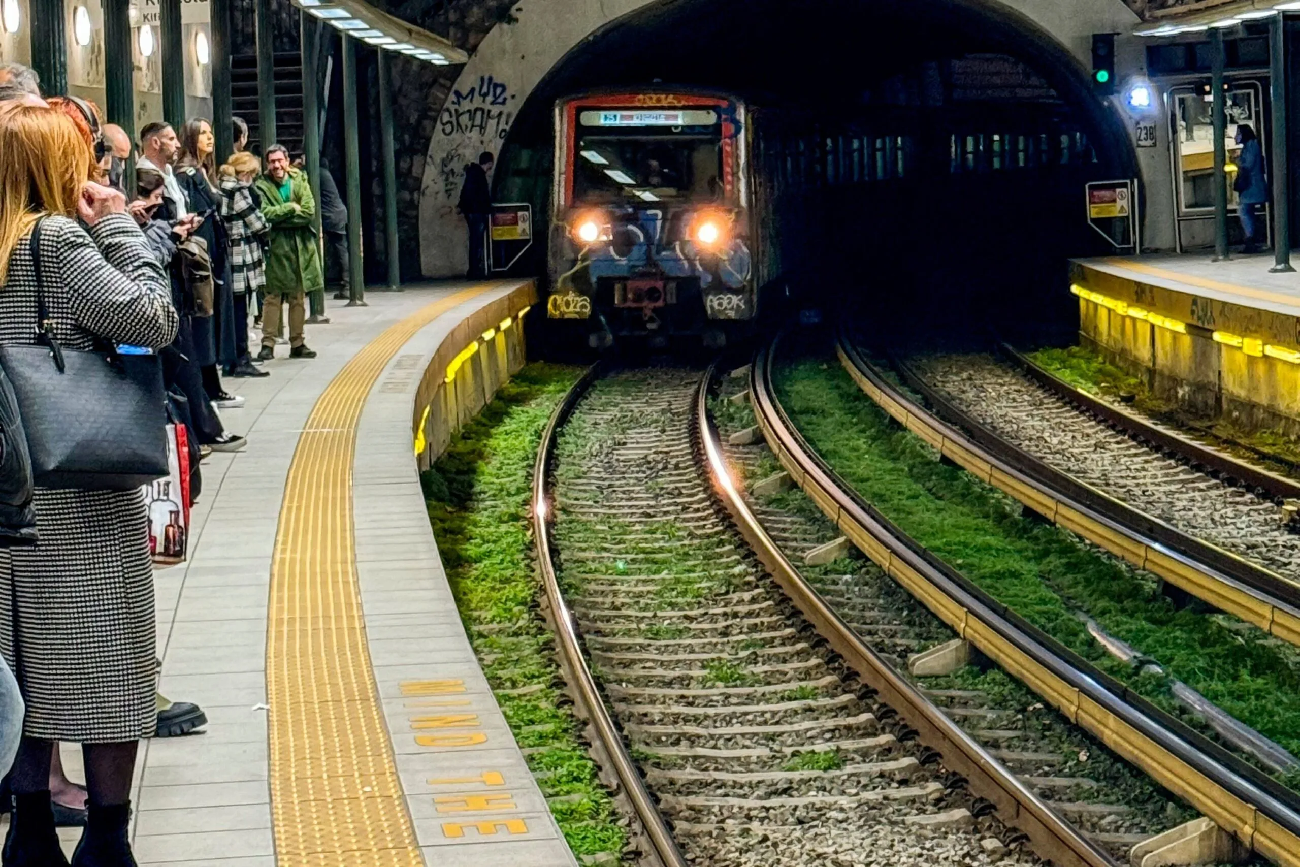 An Athens Metro Line 1 train travels through the urban rail network.