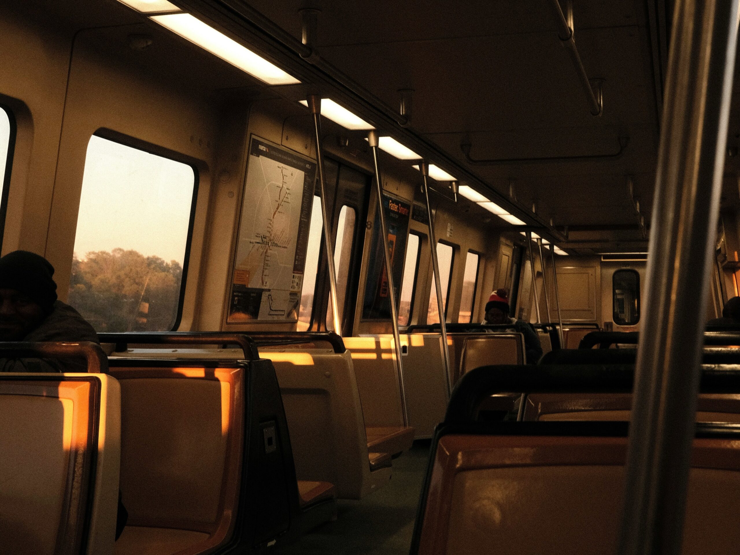 The image shows the interior of a MARTA railcar in Atlanta during a quiet evening journey.