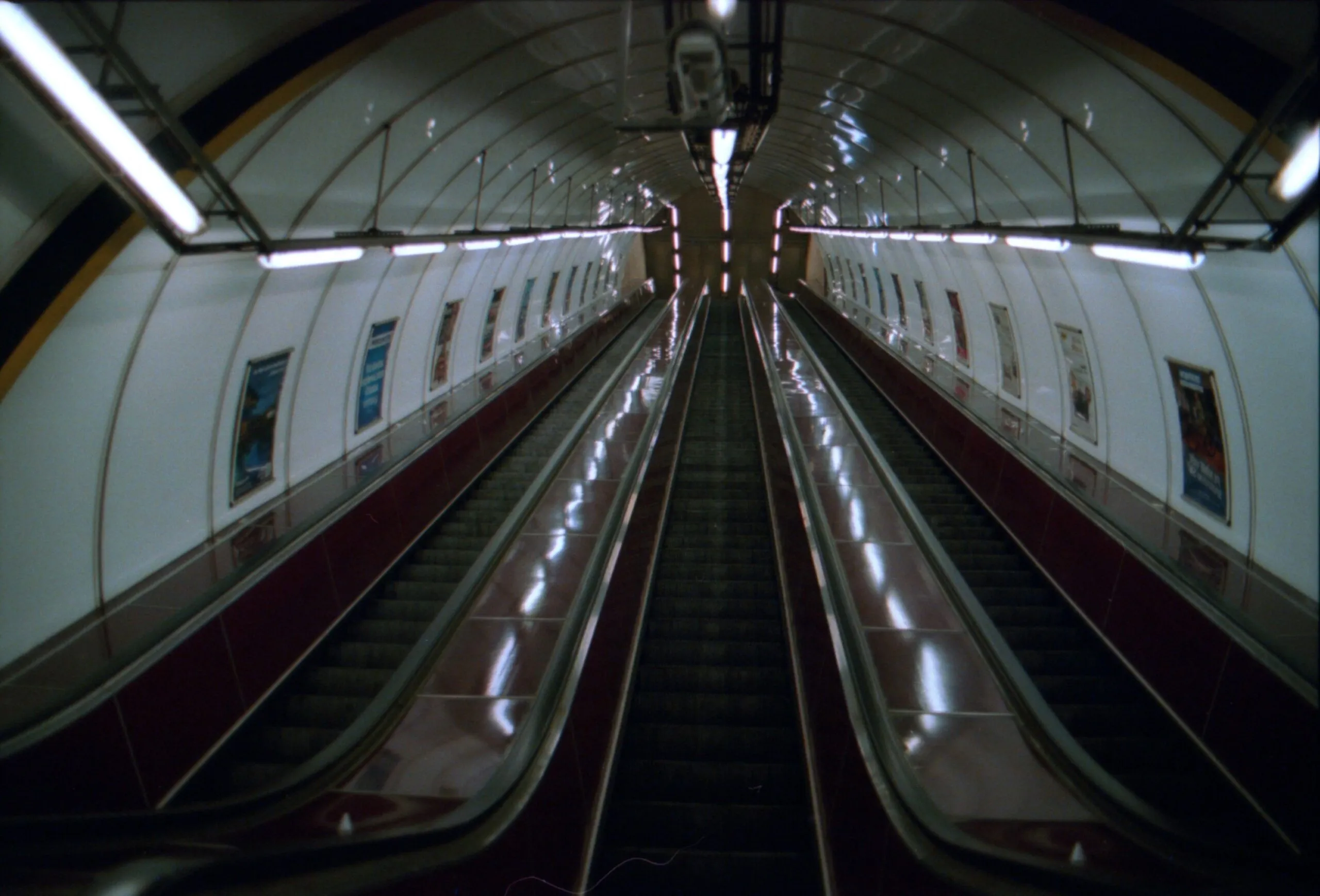 The picture shows a very long escalator descending into one of the deep stations of the Prague Metro, a network you can also explore via the Prague metro map PDF.