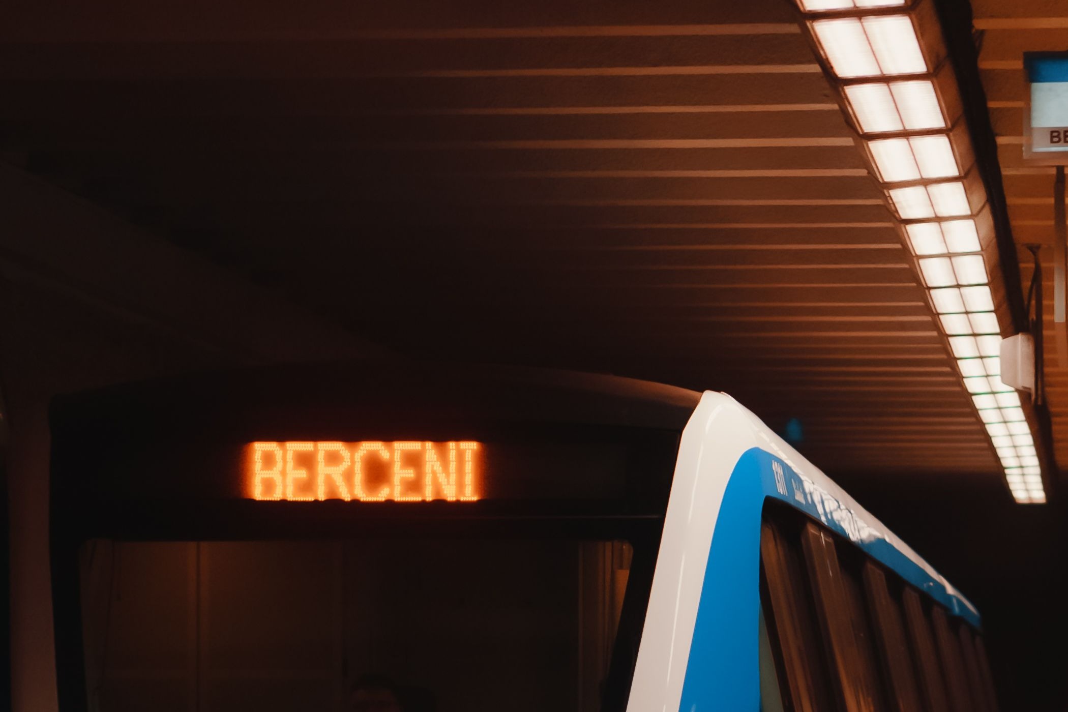 The image shows a Bucharest Metro train at Berceni station on the M2 line.