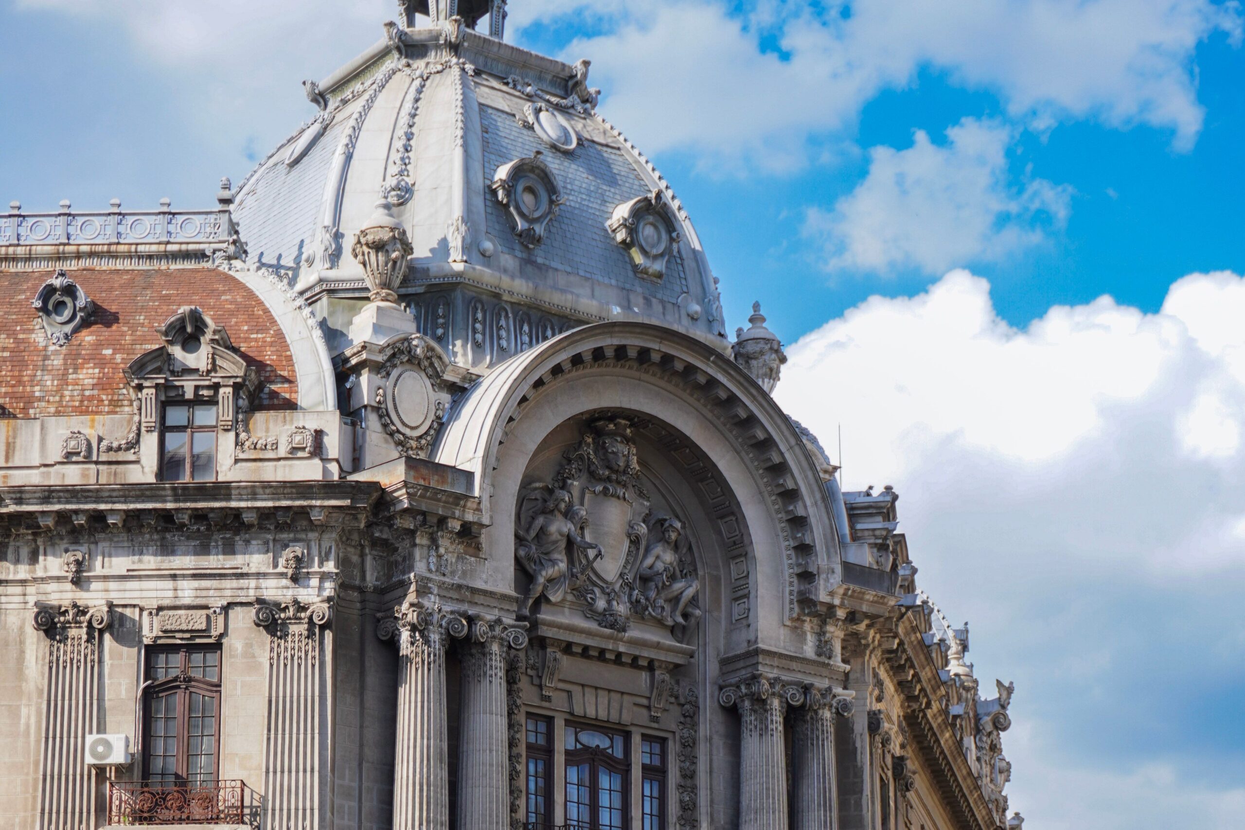 The image shows the dome of the historic CEC Palace in central Bucharest near Metro stations.