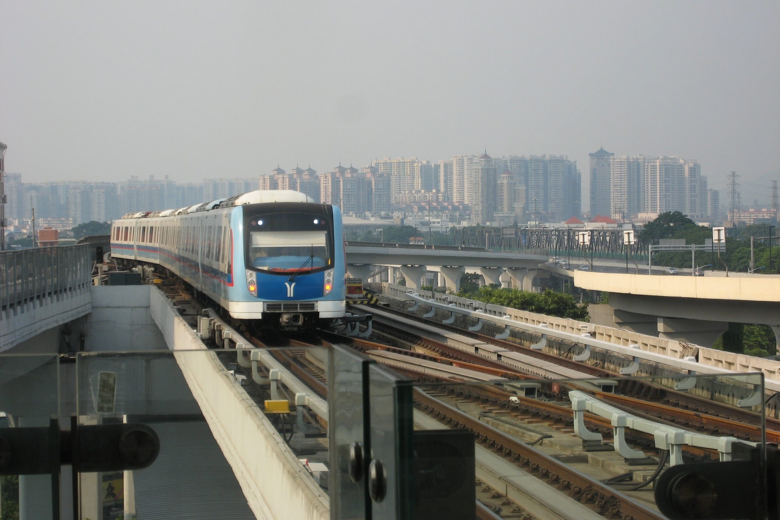 A Guangzhou Metro train approaches on an elevated section of the city's rail network.