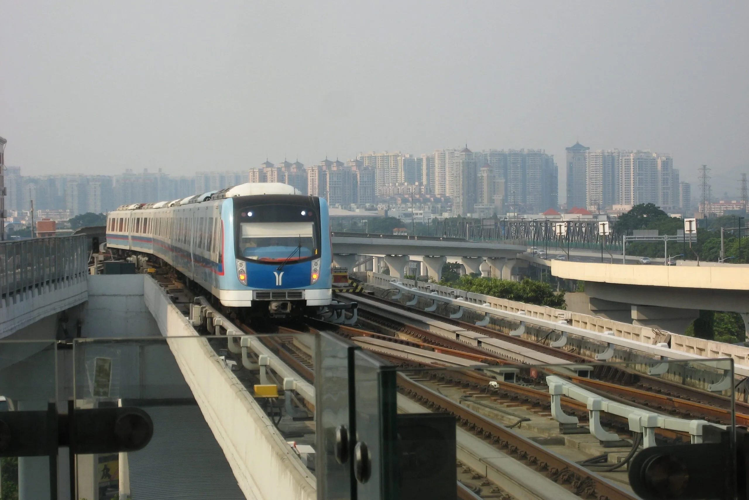 A Guangzhou Metro train approaches on an elevated section of the city's rail network.