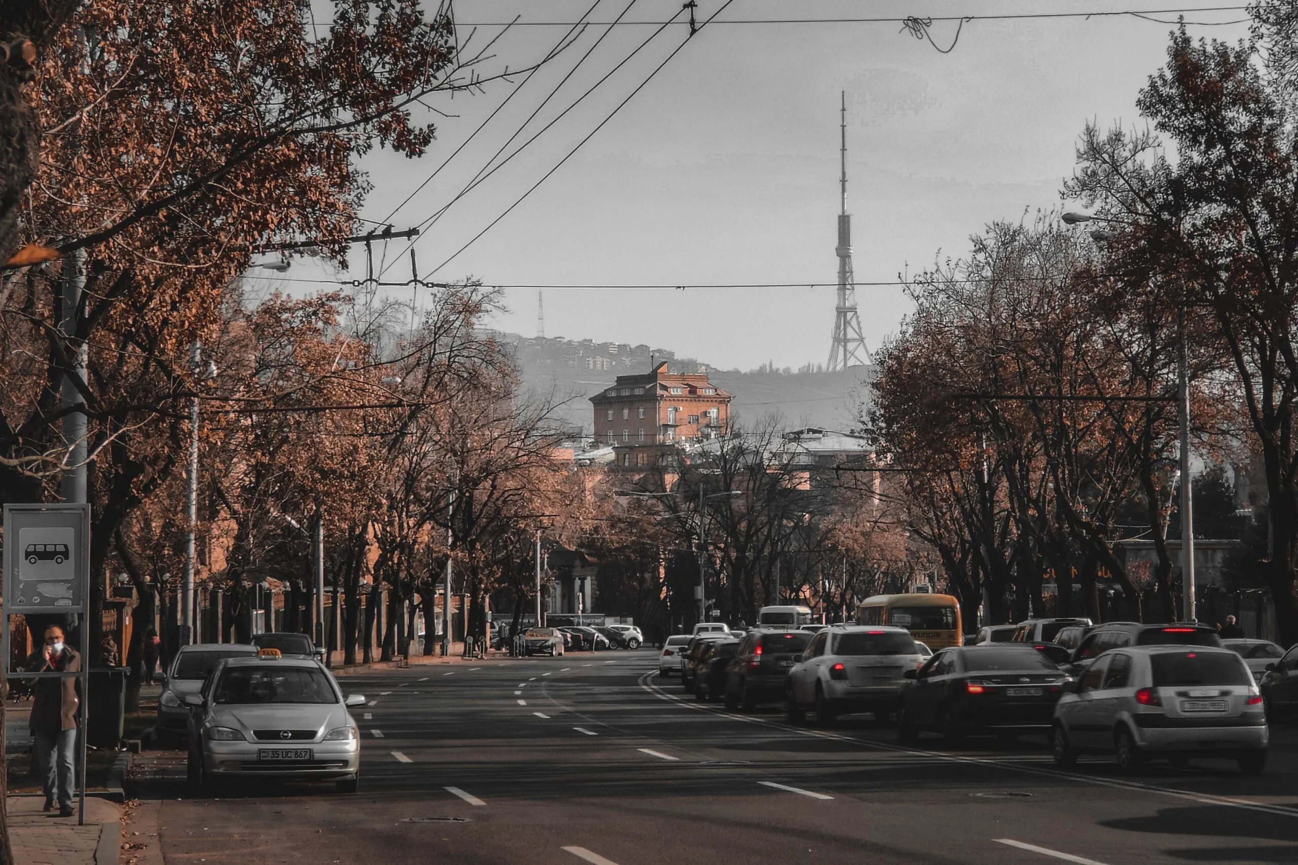 Traffic moves along a central Tbilisi street with the television tower in the background.